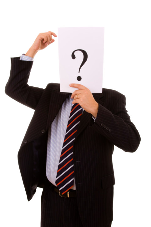 salesperson in a suit with a question mark covering his face